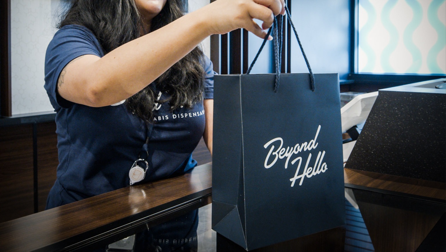 Customer receiving a NuLeaf shopping bag